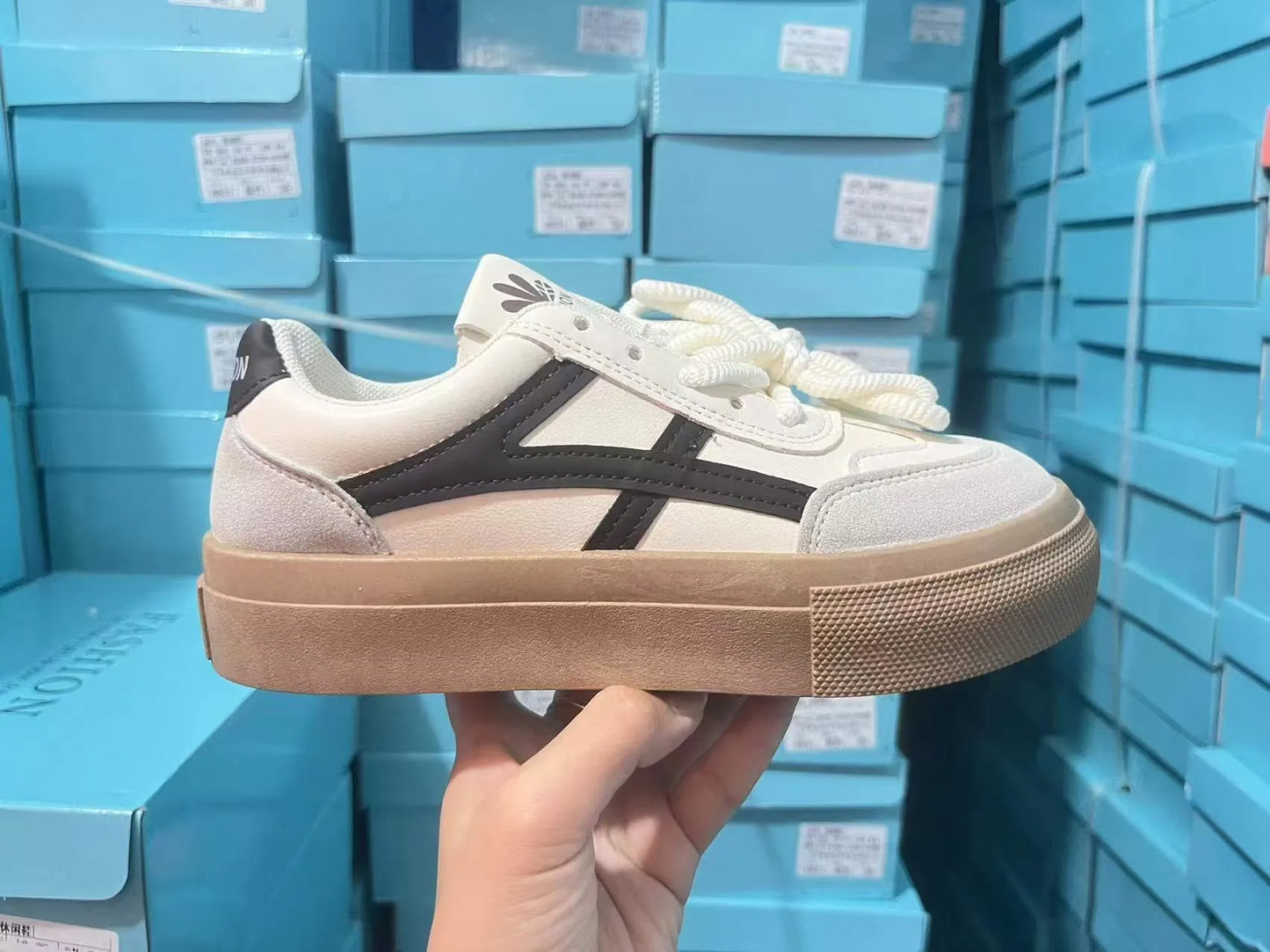 Blue and brown low-top casual sports shoes with round toe and flat rubber sole.