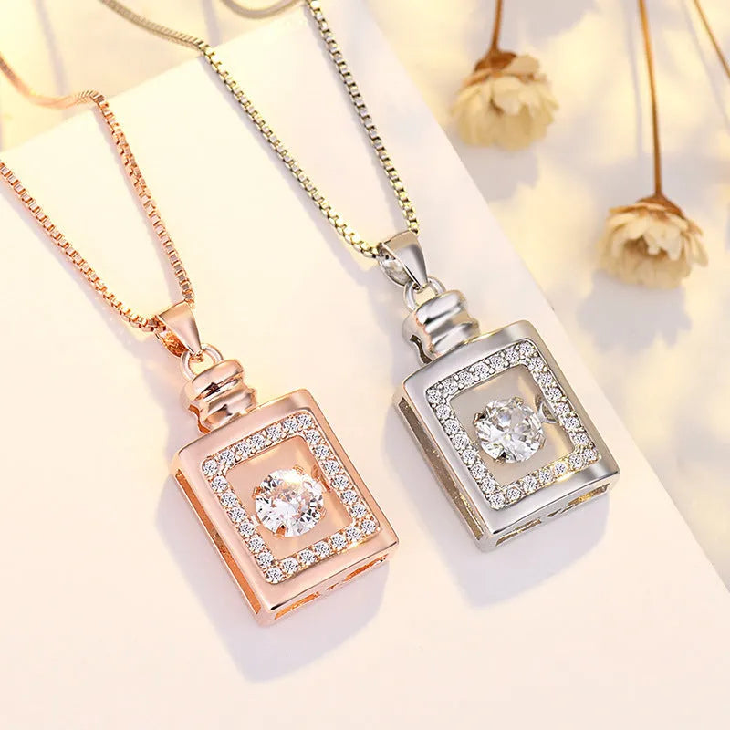Sterling silver heart-shaped pendant necklace with a small crown and bow design, shown in a rose gold finish.