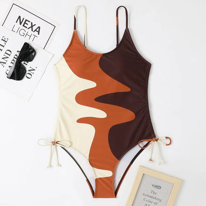 A blue one-piece swimsuit for women, showing sleeveless and backless design on a mannequin.