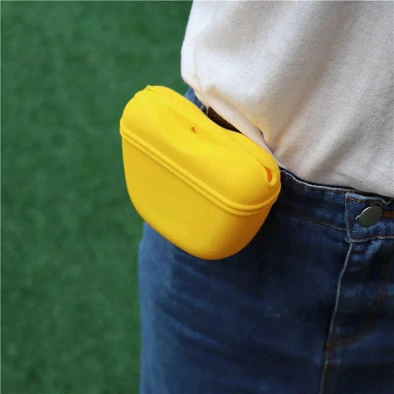 Black silicone dog training treat pouch with clip and magnetic closure shown attached to a belt.