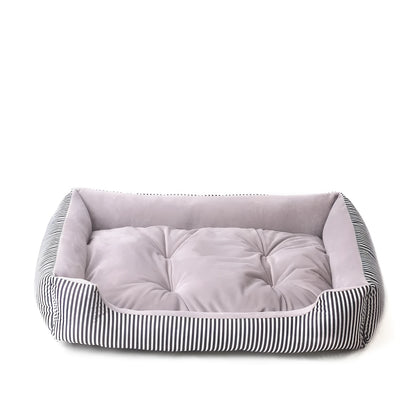Oval cloth pet bed for dogs or cats in a striped colour pattern, showing its soft cushion shape.