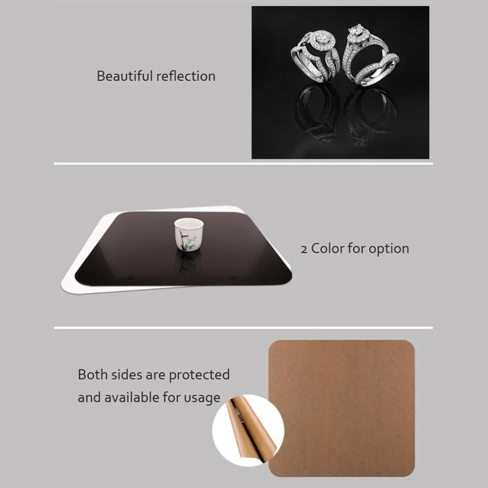 Square black and white acrylic reflection boards for product photography on a table
