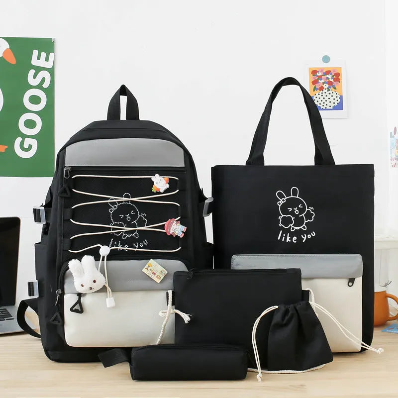 Nylon junior high school backpack in solid colour with curved shoulder straps and organisational compartments