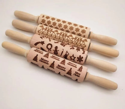 Wooden rolling pin with engraved Christmas patterns including reindeer and snowflakes on a 45cm long barrel.
