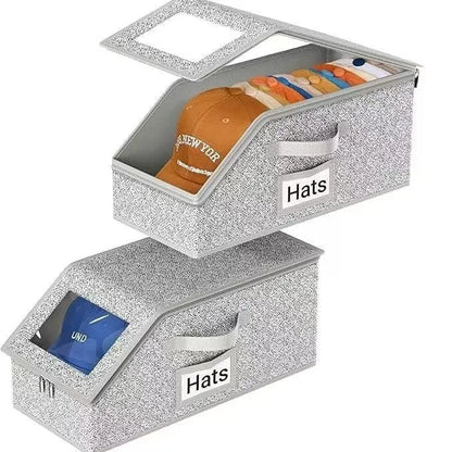 Grey foldable woven fabric storage box with dimensions 42cm by 22cm by 17cm for organising caps and sundries.