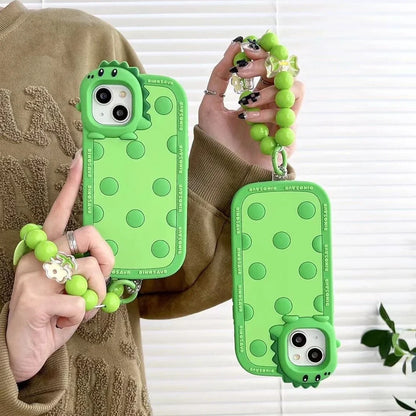 Green polka dot dinosaur silicone phone case showing back design and side protection for iPhone