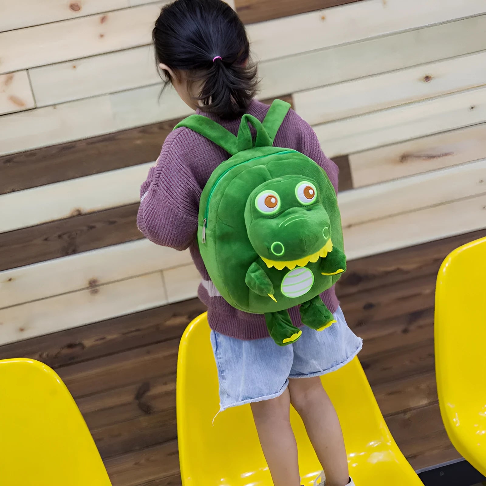 Soft blue dinosaur plush backpack with embroidery detail and a soft handle.