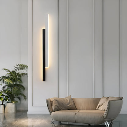 Modern strip wall lamp with acrylic shade mounted beside bed