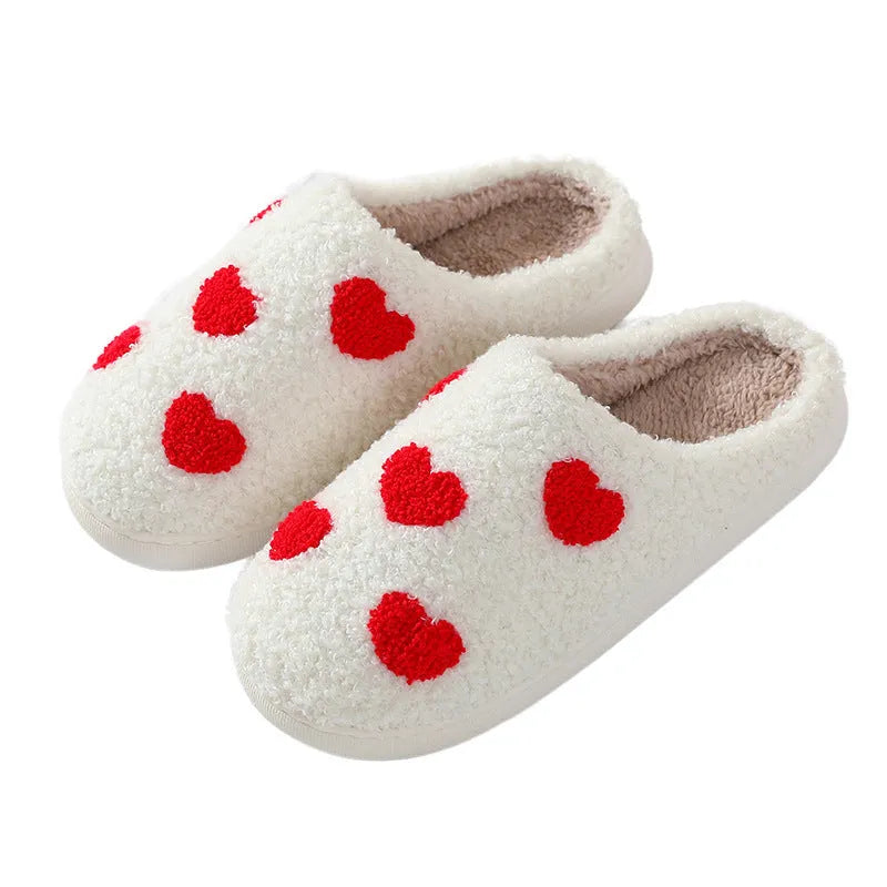 Women's plush home slippers in cartoon designs with a non-slip PVC sole.