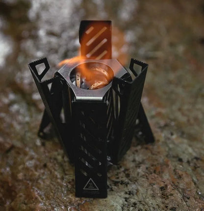 Hexagon alcohol stove in black or silver, folded to 9.5x8.5x15cm dimensions for portable camping use
