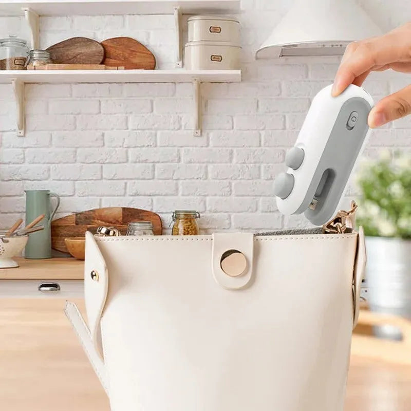 Blue and white handheld USB rechargeable heat sealer with cutter for sealing chip bags