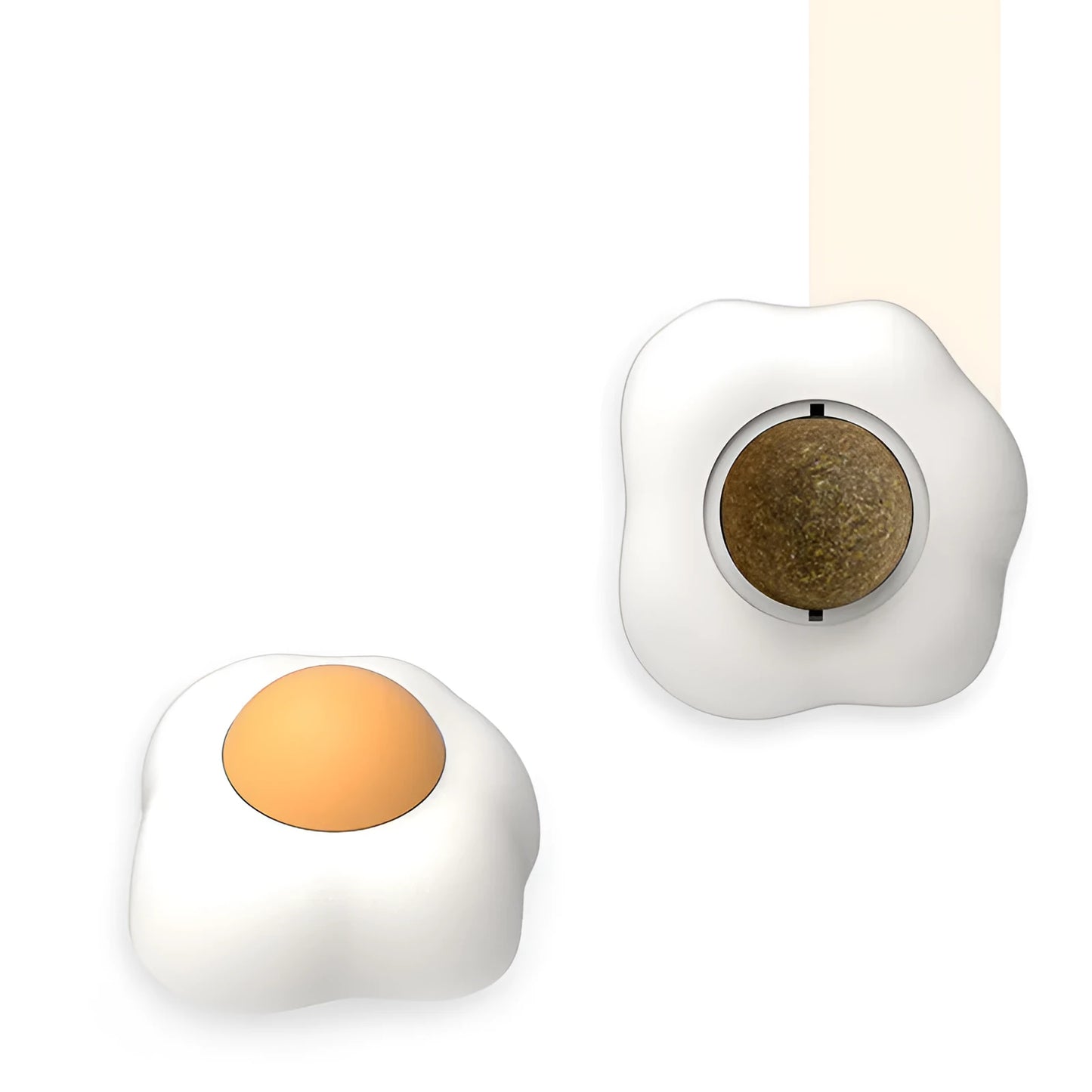 Interactive plush catnip ball toy shaped like a fried egg, stuck to a wall with a cat batting at it.