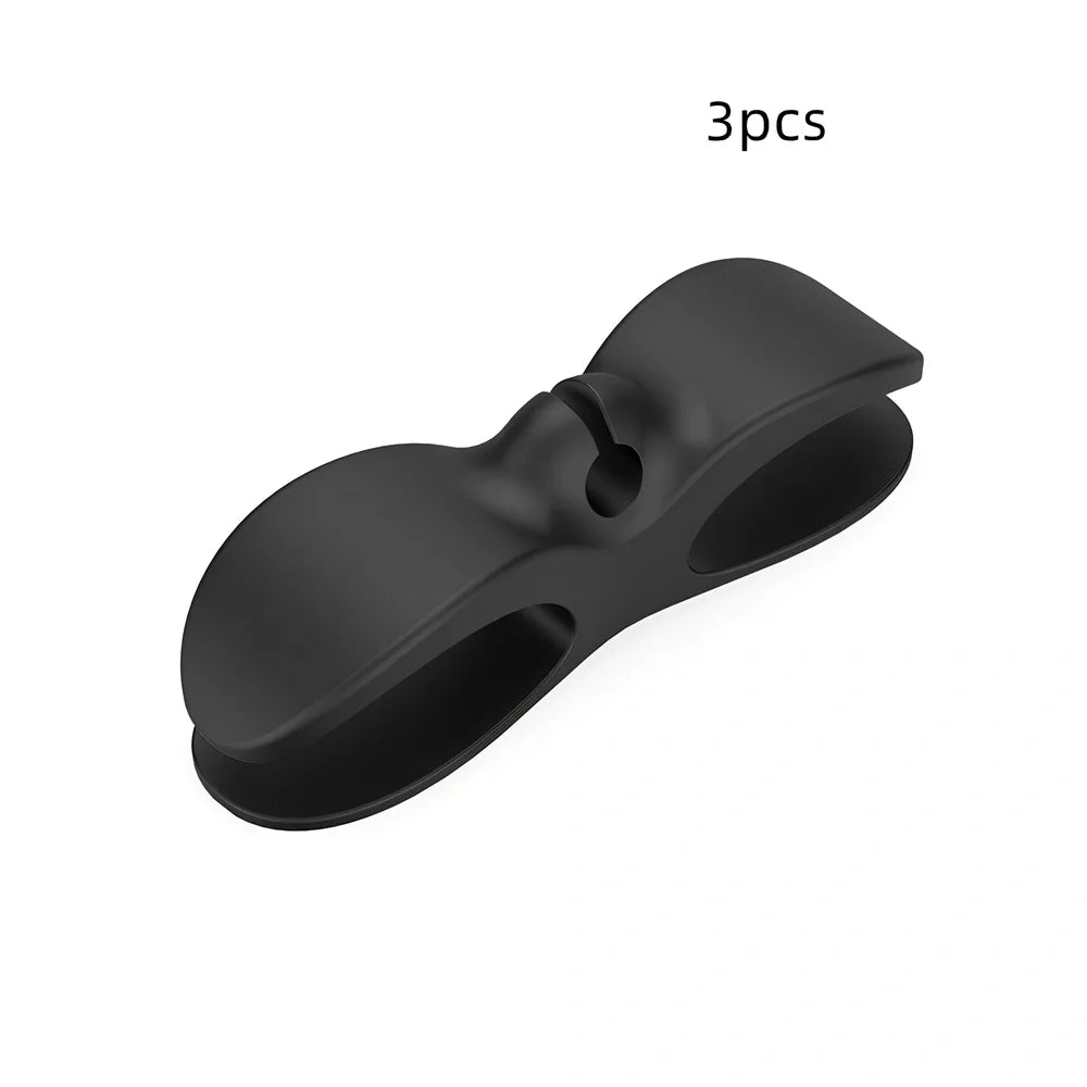 Black TPU cable organizer clips winding appliance cords on kitchen counter, 5cm size, non-marking adhesive for tidy management