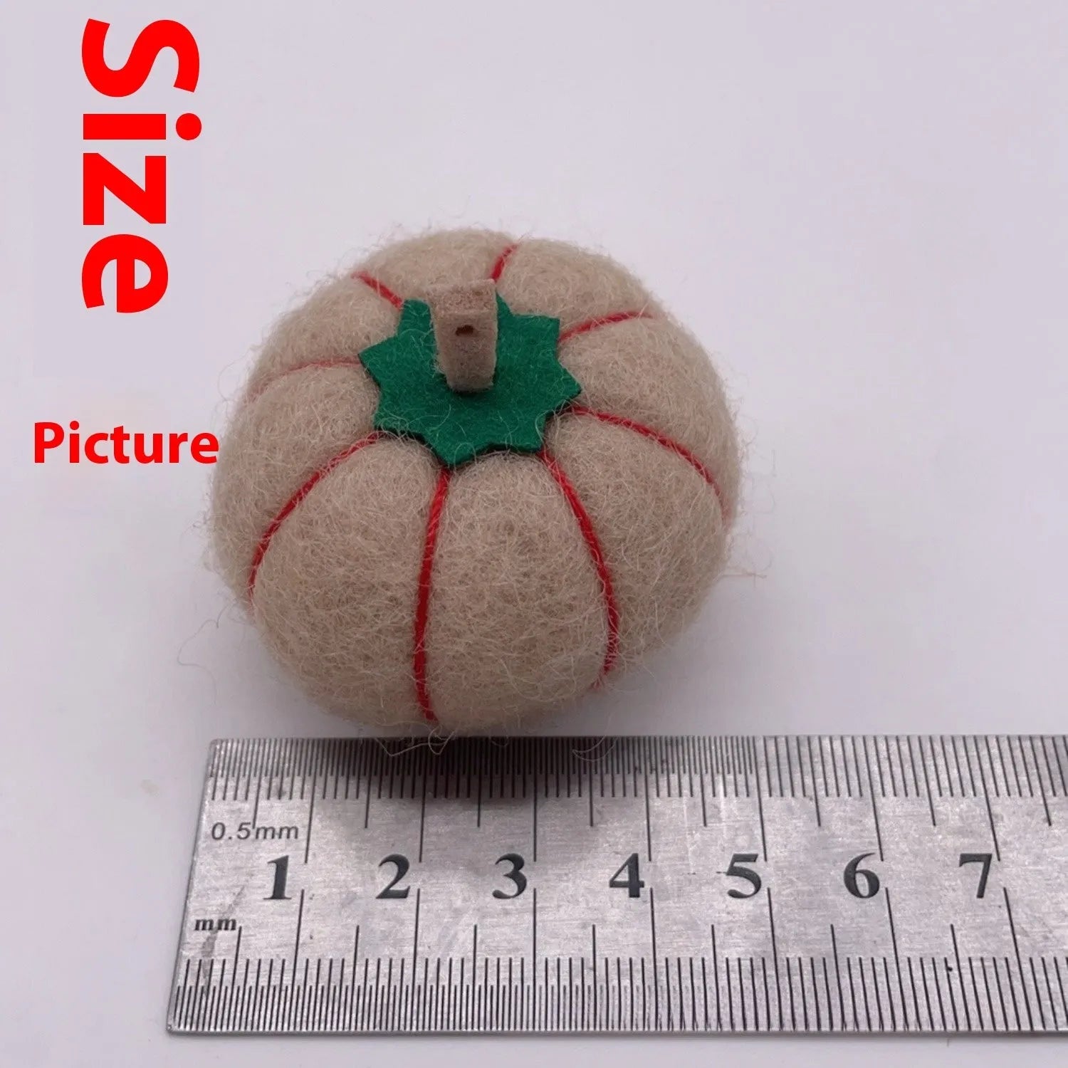 Wool felt pumpkin ornaments in various colours for doll decoration and craft projects.