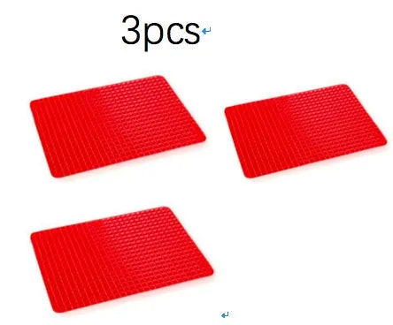 Red silicone pyramid grid cooking mat on a kitchen counter