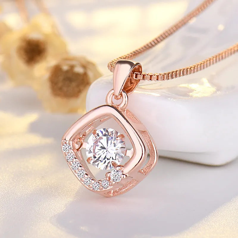 Sterling silver heart-shaped pendant necklace with a small crown and bow design, shown in a rose gold finish.