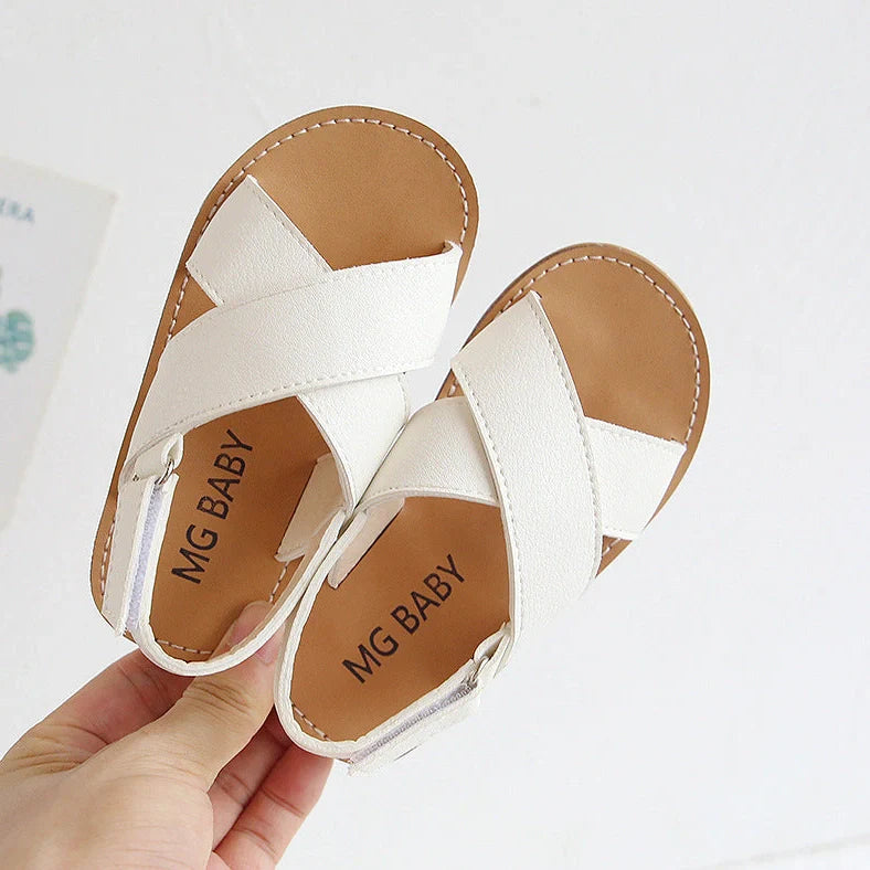 Children's black cross-strap sandals with adjustable Velcro fastening showing size range 21-30