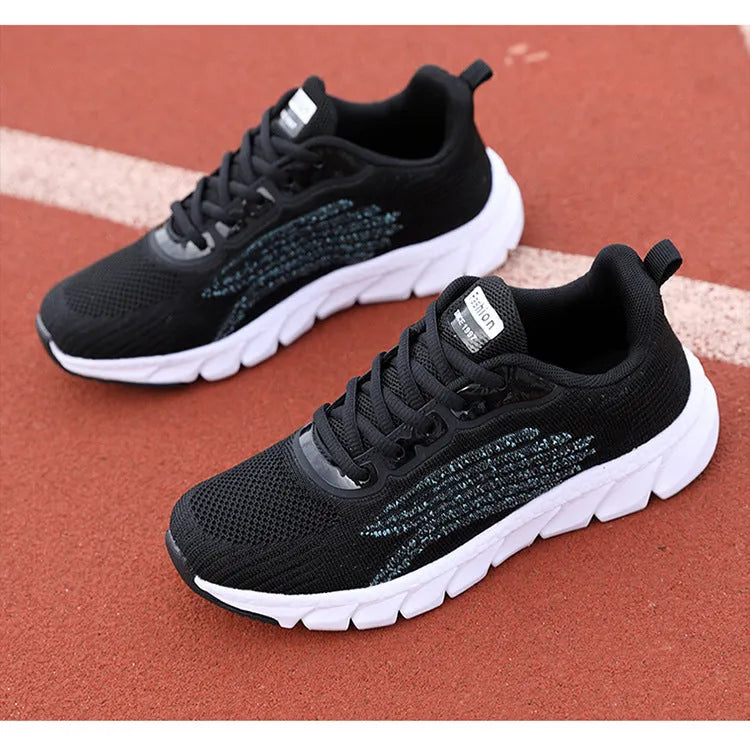 Women's black and white low-top running casual sneakers with MD sole and cross strap detail