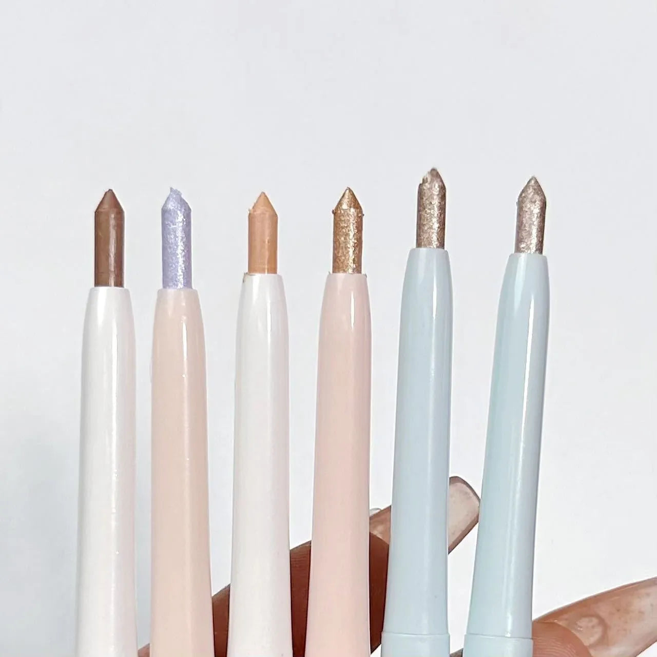 Dual-ended waterproof eyeliner and eyeshadow pencil in a silver casing, showing six colour options.