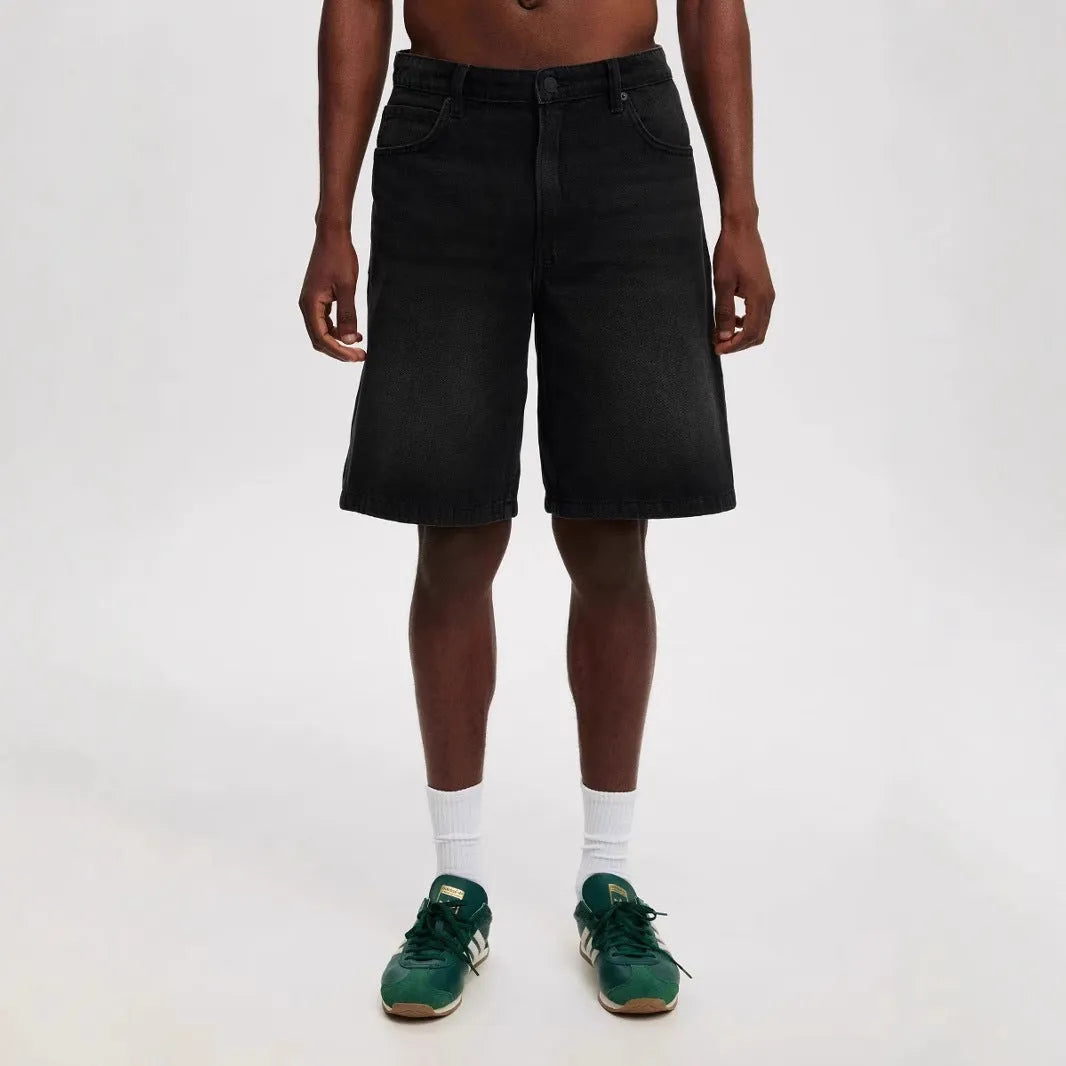 Men's light blue loose-fit straight-leg cotton jeans on a neutral background.
