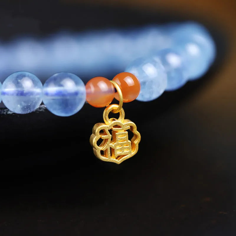 Ice translucent aquamarine crystal bracelet with 8mm round beads and sequin details on a wrist.