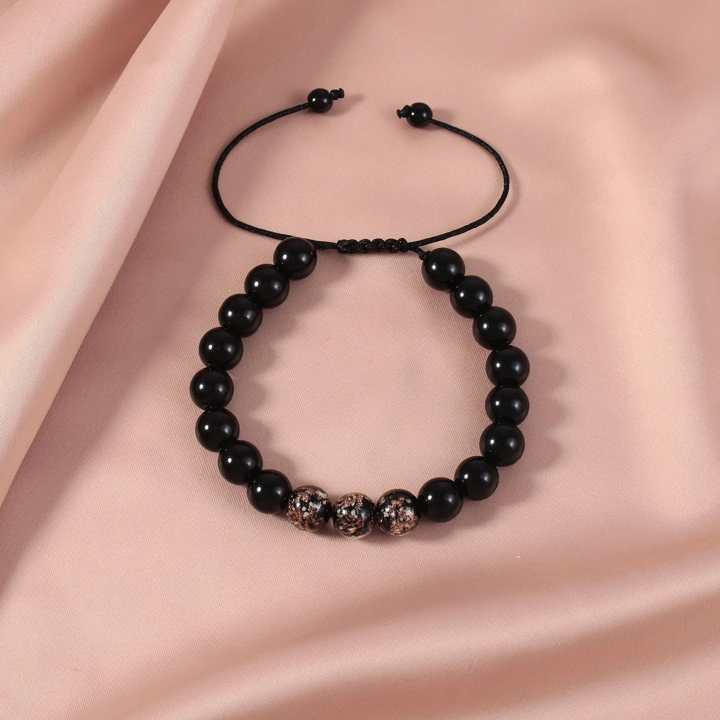 Adjustable bracelet with luminous geometric glass beads in six colour options on a wrist