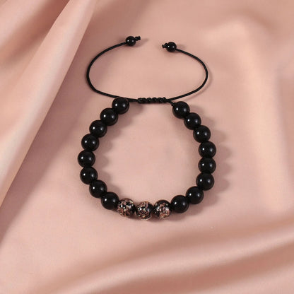 Adjustable bracelet with luminous geometric glass beads in six colour options on a wrist