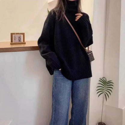 Women's turtleneck sweater in loose fit with thick curling pile collar, available in red, camel, grey, and black colours