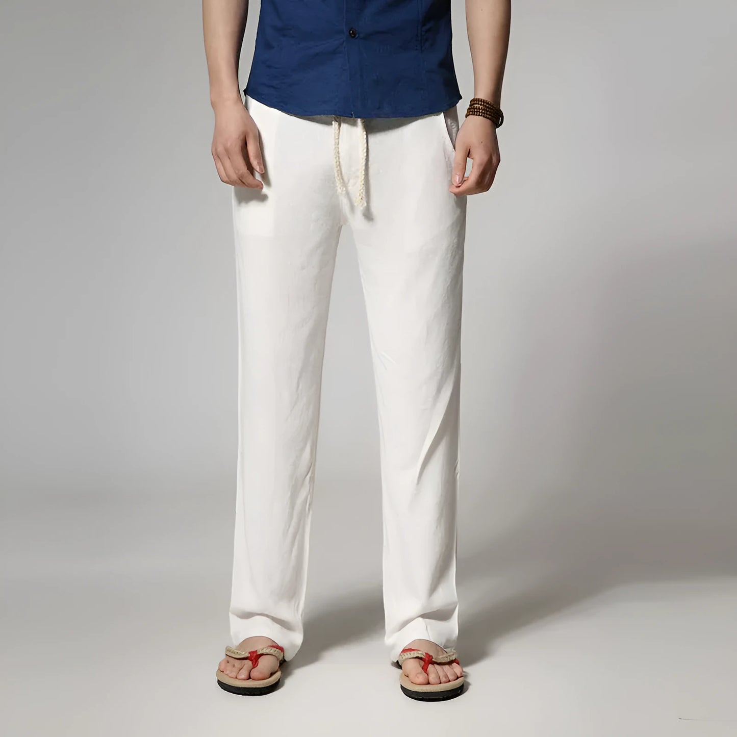 Men's straight leg casual trousers in cotton linen blend fabric showing loose fit and zip fly closure