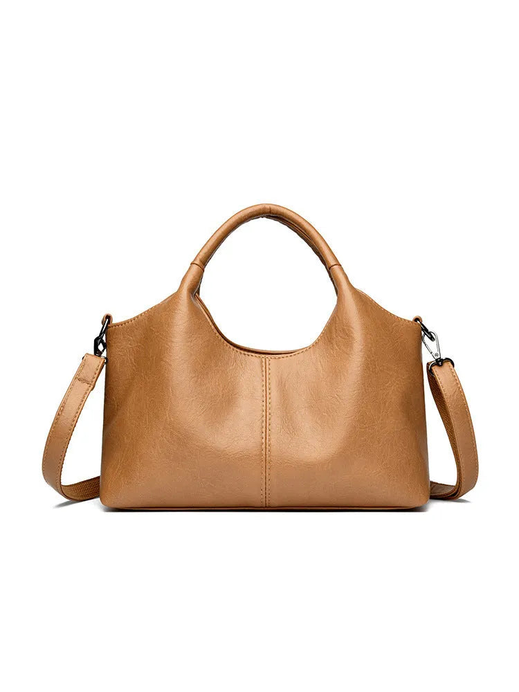 Soft genuine leather women's crossbody bag in beige with large capacity and adjustable strap.
