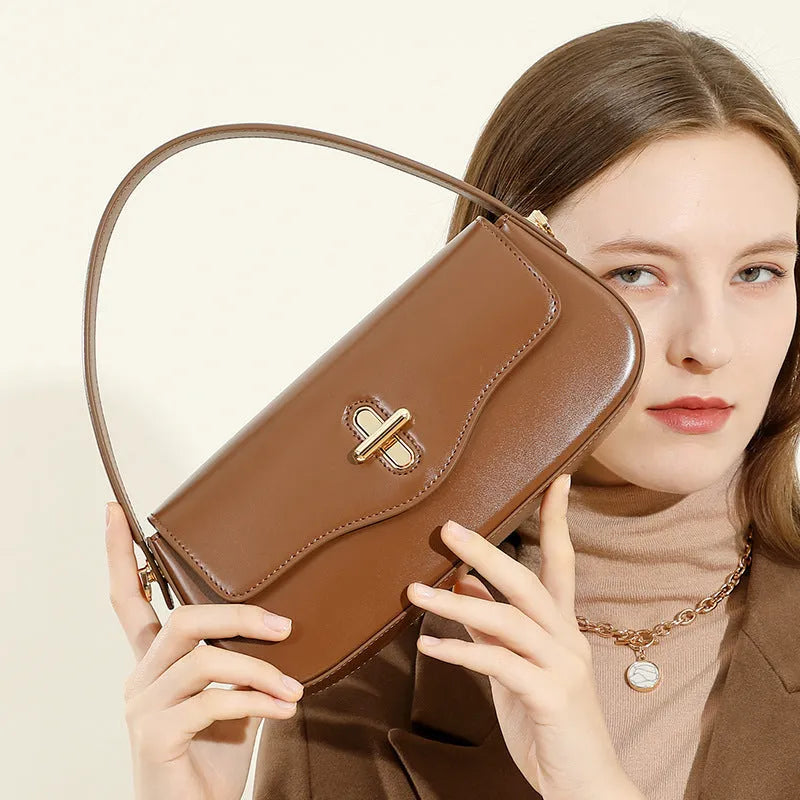 Genuine leather baguette handbag in clamshell design with internal organiser compartments