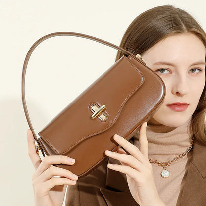 Genuine leather baguette handbag in clamshell design with internal organiser compartments