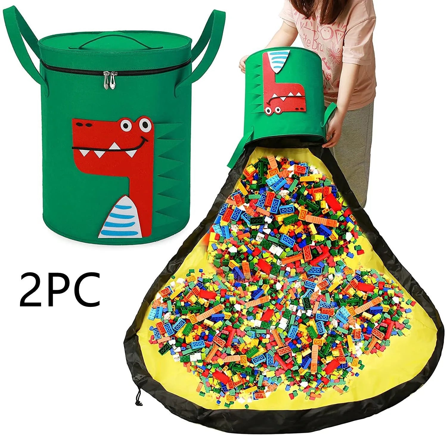 Green felt storage cube with pull rope unfolded into a large square play mat on a wooden floor.