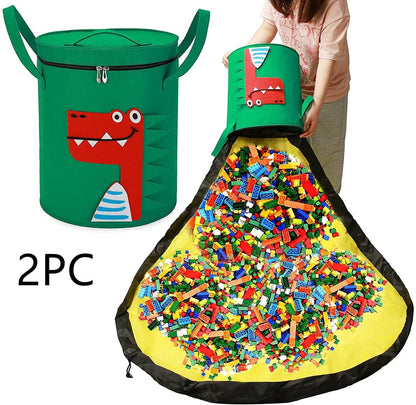 Green felt storage cube with pull rope unfolded into a large square play mat on a wooden floor.