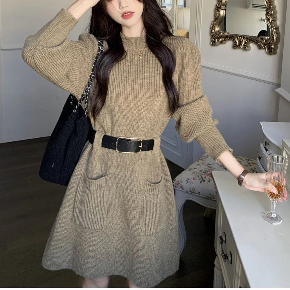 Women's long sleeve loose knitted dress in beige with black belt, showing high waist design and free size fit