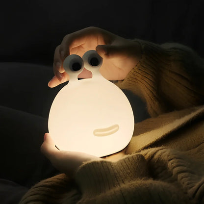White cartoon slug night light with touch activation and USB power connection