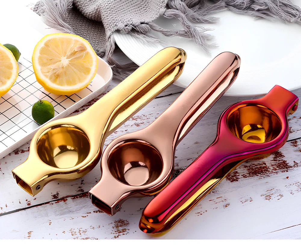 Manual stainless steel juicer with 5.5cm feed opening in gold finish on kitchen counter