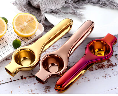 Manual stainless steel juicer with 5.5cm feed opening in gold finish on kitchen counter
