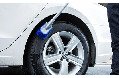 Car tire wheel brush with long handle and twisted yarn bristles for wheel hub cleaning.