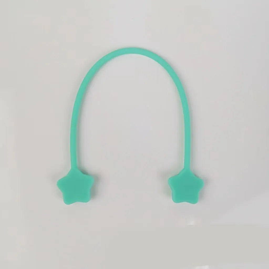 Compact purple silicone cable winder with magnet, shown coiling a white headphone cable.