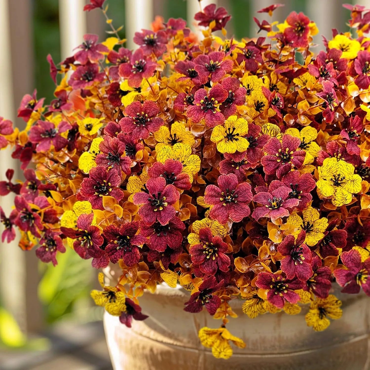 Autumn coloured artificial flower bouquet with plastic and silk flowers for decoration.