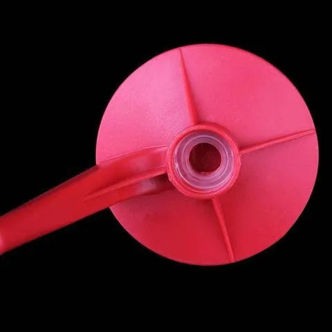 Red plastic soda dispenser attached to inverted 2-litre bottle with push-button mechanism