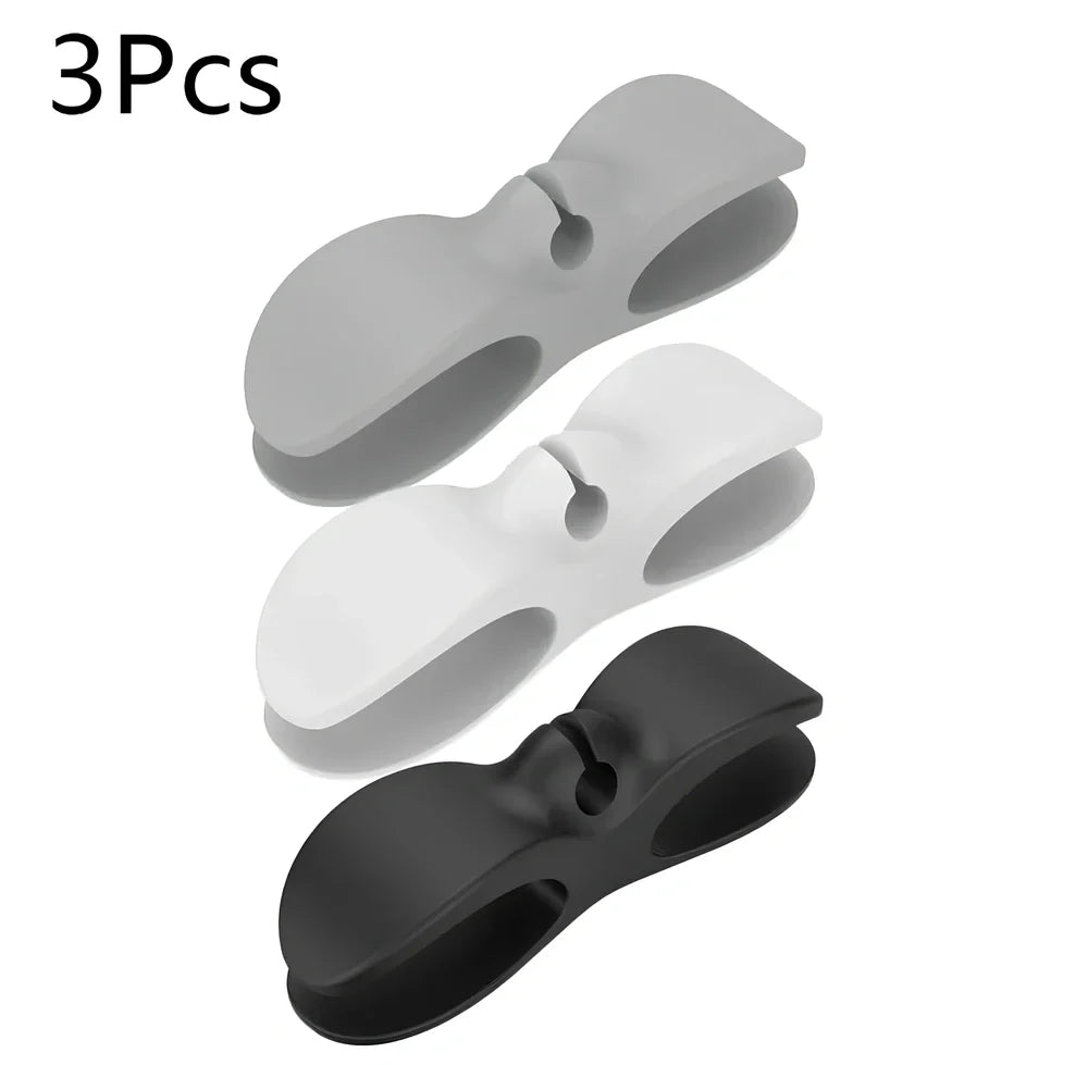 Black TPU cable organizer clips winding appliance cords on kitchen counter, 5cm size, non-marking adhesive for tidy management