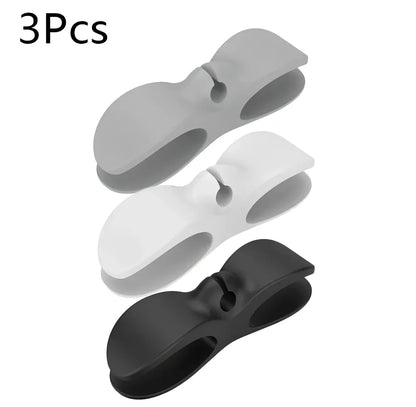 Black TPU cable organizer clips winding appliance cords on kitchen counter, 5cm size, non-marking adhesive for tidy management