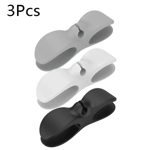 Black TPU cable organizer clips winding appliance cords on kitchen counter, 5cm size, non-marking adhesive for tidy management
