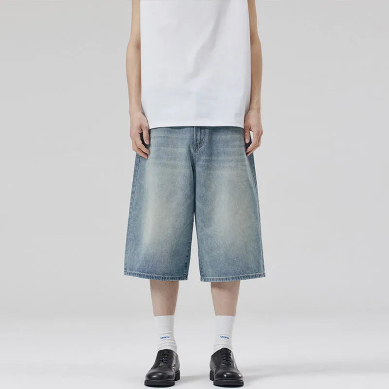 Men's loose straight denim shorts in light blue with cropped length ending above ankle, straight-leg cut
