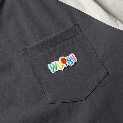 Dark grey loose fit men's t-shirt with contrast colour raglan sleeves on a hanger.