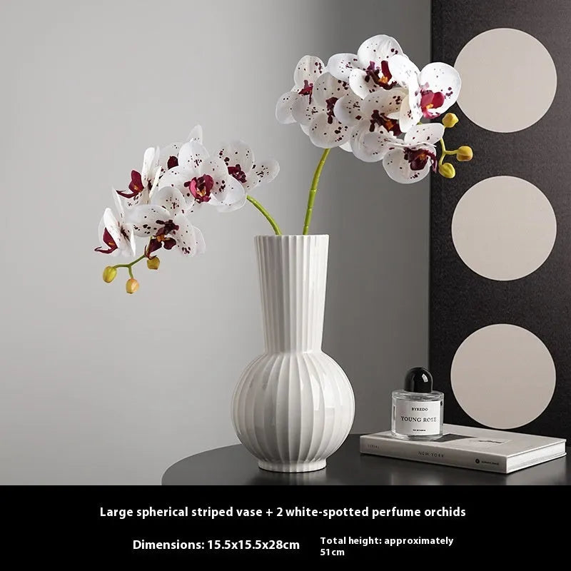 White ceramic ball-shaped vase with striped pattern, shown in small and large sizes with orchid arrangements