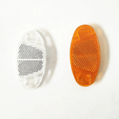 Four white bicycle spoke reflectors showing dimensions of 7.2cm by 3.5cm