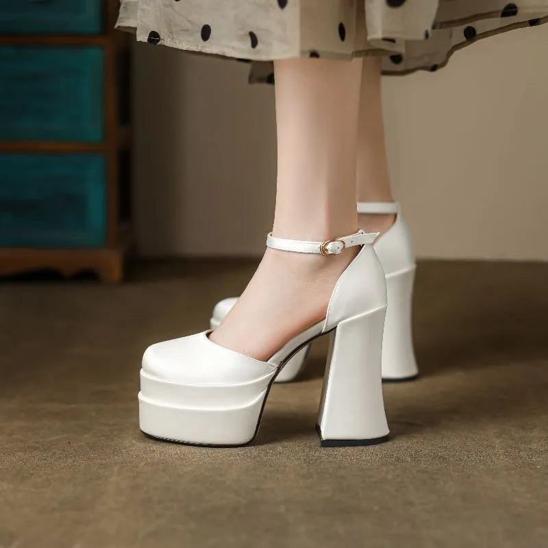 Women's white chunky heel platform pumps with a round toe and mid-calf cut.
